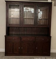 Full frontal view showing overall cabinet design, doors, drawers, and finish