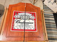 Closed wood cabinet showing Budweiser logo
