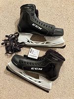Pair of CCM RW300 skates side view, tags and laces visible