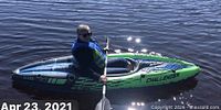 Person paddling green Intex Challenger kayak on water