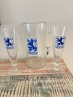 Pitcher and two pilsner glasses displayed together