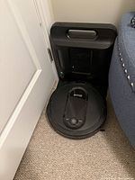 Robot vacuum seated in its charging dock
