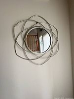 Full view of round mirror on wall showing overall design
