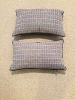 Front views of both multicolor tweed pillows side by side