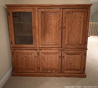 Front view showing six-door oak cabinet