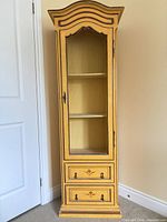 Full view of tall yellow French Provincial cabinet with chicken-wire door and drawers