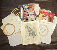 Overview of hoops, floss bag, bobbin pack, organizer, fabric, pattern book, pattern sheets