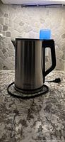 Kettle on countertop showing full exterior and power cord