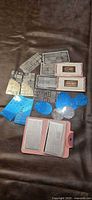 Overview of all stamping plates, boxed Gelmoment plates, loose plates with blue film, round discs and open binder