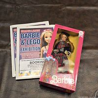 Boxed Scottish Barbie doll with stack of brochures