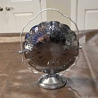 Front view of silver-tone tri-dish stand upright showing overall structure and condition