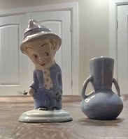 Front view of figurine and vase showing overall design and color