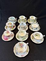All ten teacup and saucer sets arranged in rows