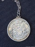 Close-up of coin pendant front detail