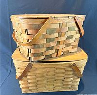 Both woven maple picnic baskets stacked showing exterior finishes