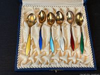 Six enamel-handled sterling spoons in case