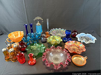 Full group shot of coloured glass items showing overall quantity and variety