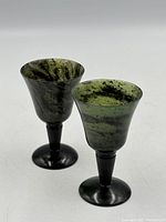Two spinach jade wine cups upright