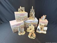 Group shot of seven cottages, several on original David Winter boxes