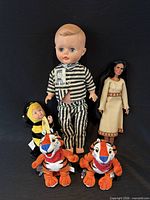 Group shot of all five dolls and plush animals