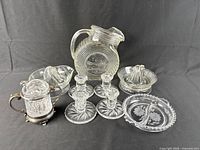 Entire lot showing pitcher, candlesticks, juicers, serving dish and nut dish
