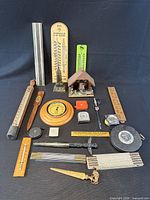 Entire lot overview showing thermometers, tapes, letter openers and other tools