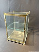 Full view of brass and glass display cabinet