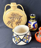 All four pottery pieces grouped: tan round vase, Gouda bud vase, crackle Art Deco vase, red fat lava vase