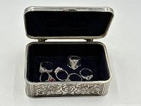 Open jewellery box showing six rings inside