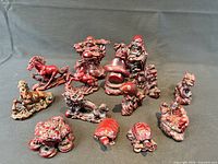 Group shot of all 14 red resin Chinese figurines