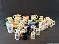 Group shot of all 31 miniature pitchers and mugs
