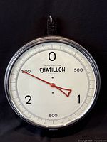 Front view of Chatillon hanging scale showing dial, pointer and hanging loop