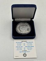 Coin in blue velvet box with COA card showing mintage numbers