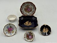 Front view of all six miniature Limoges dishes and bowl