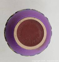Underside showing maker’s mark and model number on purple glazed base