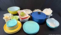 Group shot of entire lot including Dutch oven, plates, bowls, casseroles