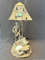 Full front view of lamp showing shepherd figure, sheep, roof canopy, stained glass