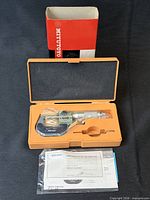 Micrometer in orange case with paperwork and outer box