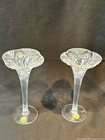Pair of crystal candlestick holders standing side by side