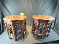 Pair of octagonal folding tables side by side, top and base visible