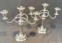 Both assembled three-light candelabra displayed side by side