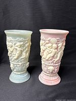 Front view of both pastel vases showing cherub relief