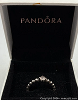 Ring in open Pandora box showing branding and interior