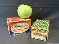 Both original boxes side by side with size reference apple
