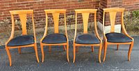 Front view of all four dining chairs showing overall design