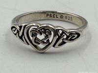 Close-up of ring showing Celtic heart design and PSCL © 925 stamp
