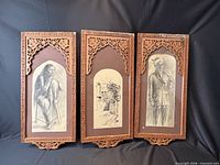 Three framed charcoal drawings together