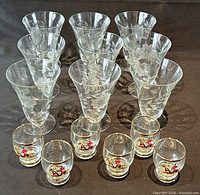 Group of nine tall etched Cornflower glasses and six equestrian shot glasses front view