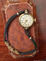 Watch on aged presentation case showing full view and band