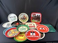 Front view showing assorted advertising trays stacked and standing